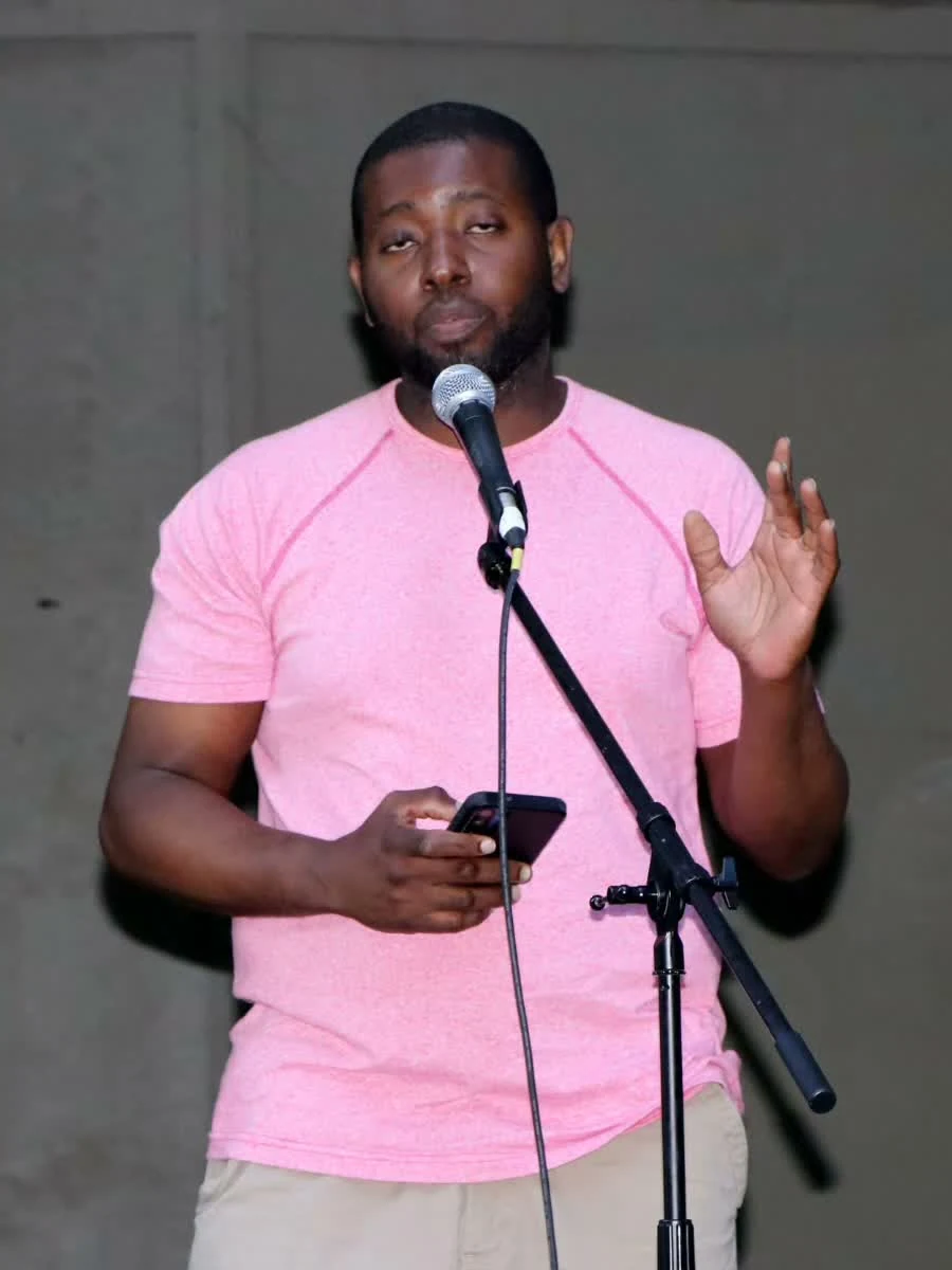 Marlo Browne reading at a microphone